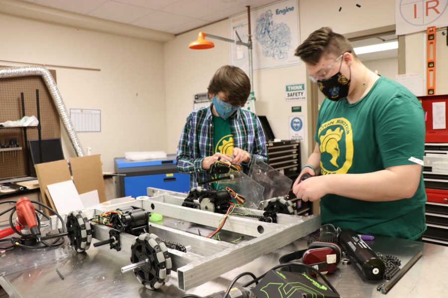 Jacob Bruesch (left) and Kass Caugh (right) work together on the construction of this year’s FRC robot photo: A. Mcfadden