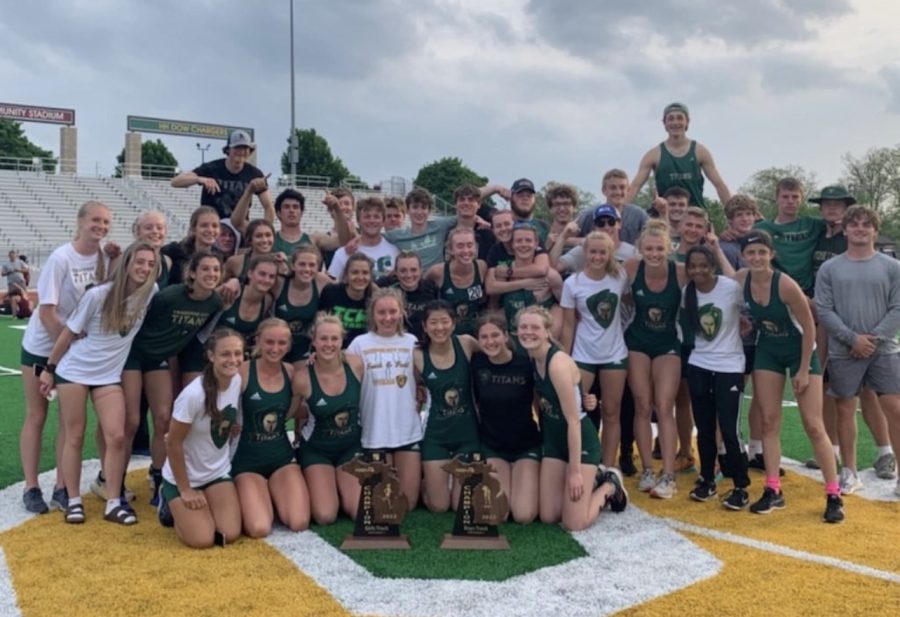 Boys+and+girls+track+teams+smile+after+winning+Regional+Champions+on+May+20%2C+2022.+