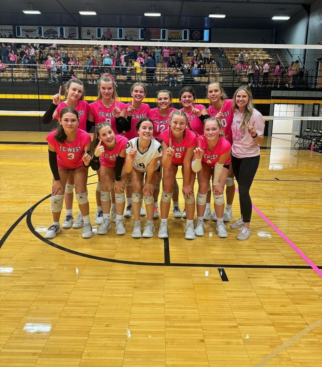 The+2023+freshman+volleyball+team+stands+together+after+the+Pink+Game.+Photo+Credit%3A+Emily+Baumann