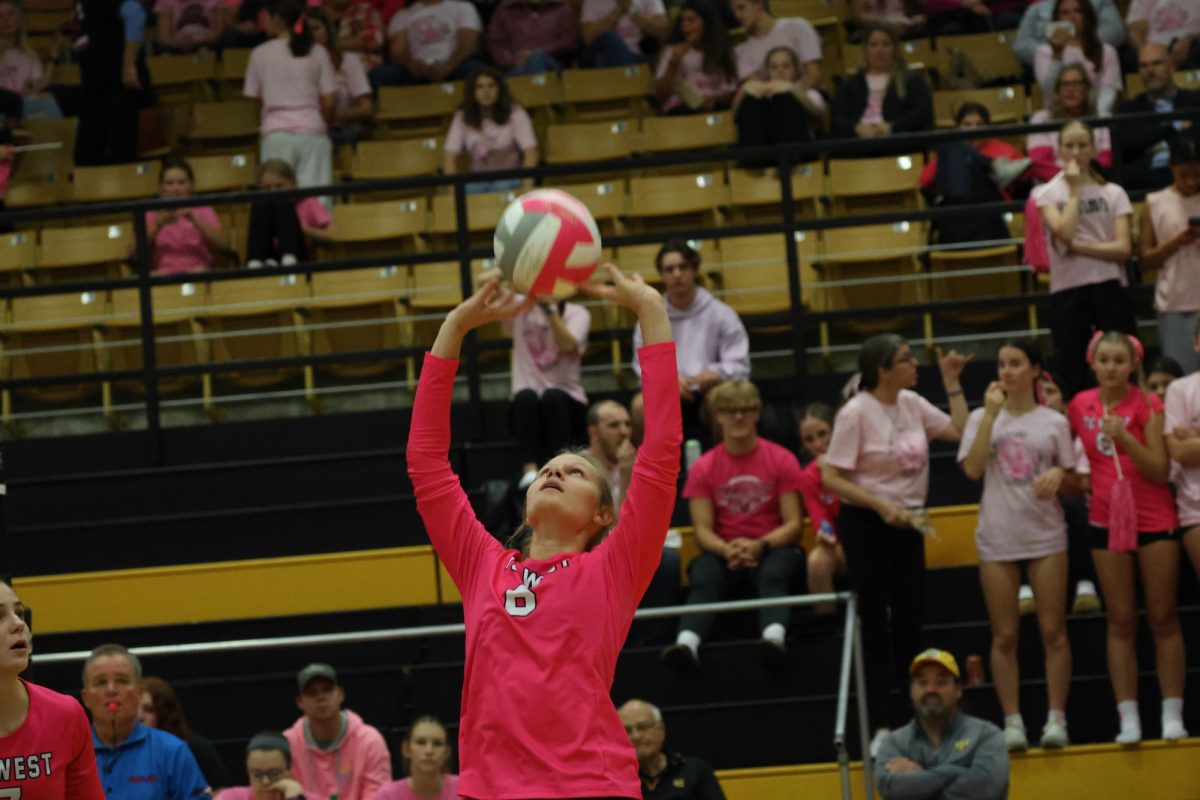 A player sets the ball during this years pink game.