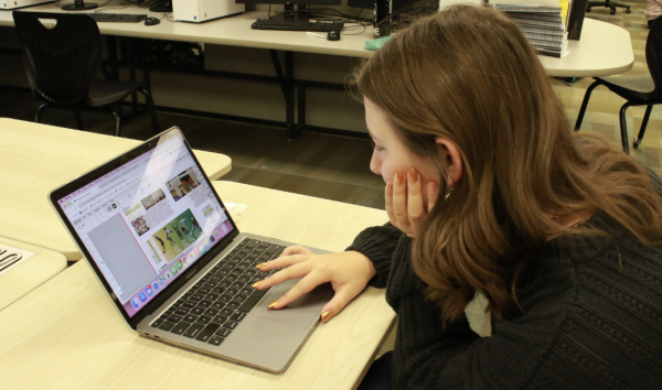 Zoe Phend works on editing pages of this years yearbook