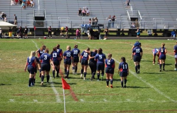 Rugby team comes together on the pitch. Photo Courtesy: Lex Leonard