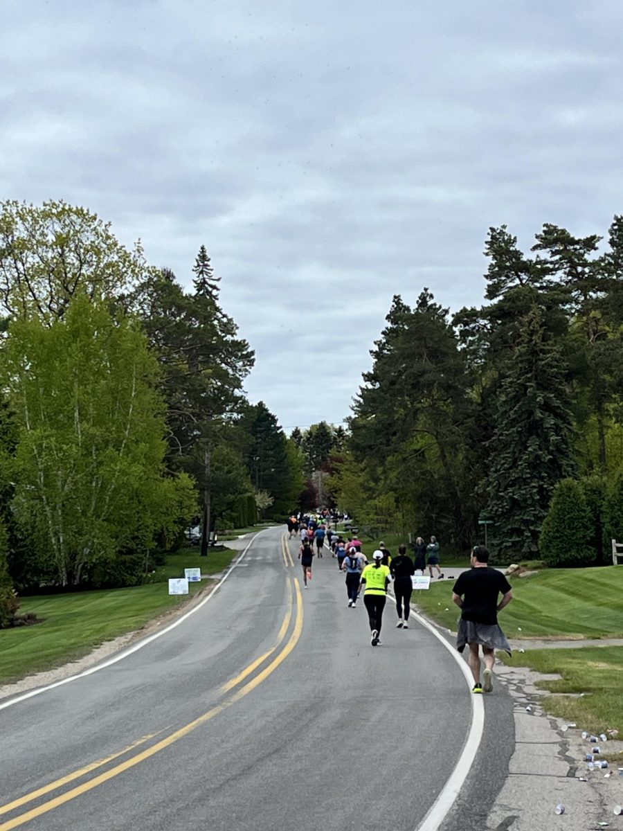 Athletes from both the marathon and the half marathon run down East Shore Road during the Bayshore Marathon. Photo Credit: M. Gartland