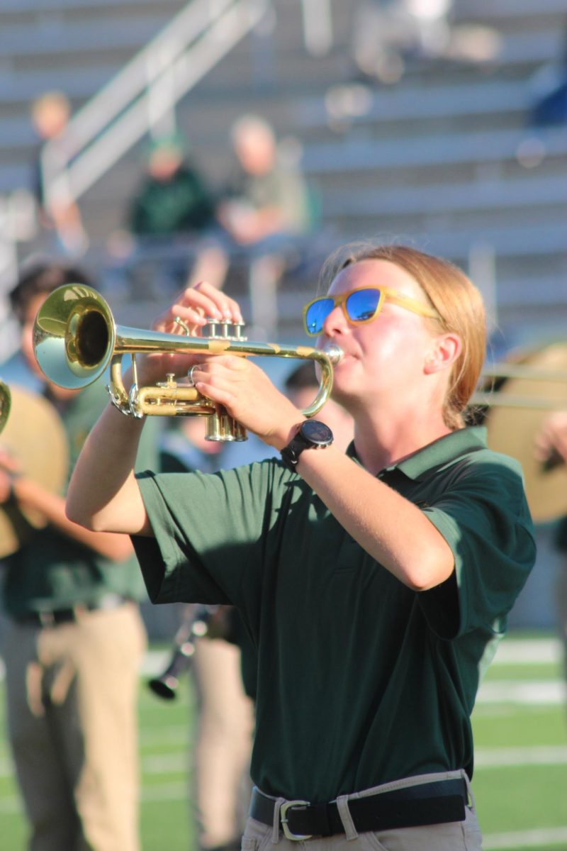 Ava Zeratsky plays the trumpet with the marching band during the halftime performance of a football game. Photo Courtesy: A. Zeratsky