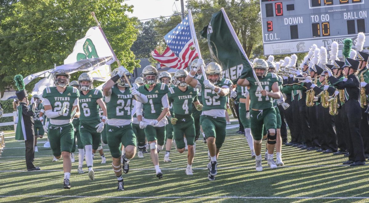 From left, Senior Cade Laurent, Senior Nick Klein, Senior Drew Esper, Senior Dylan Dunklow, Senior Will Turnquist, Senior Jackson Gallagher, Senior Owen Wohlfert. Titan Varsity Football team runs out onto the field for their week one matchup against Howell. That was just one of many challenging games that West has had to endure this season. “A lot can happen in the course of the football season, we just gotta make sure to keep everyone together and keep working as a team,”  senior captain Drew Esper said.