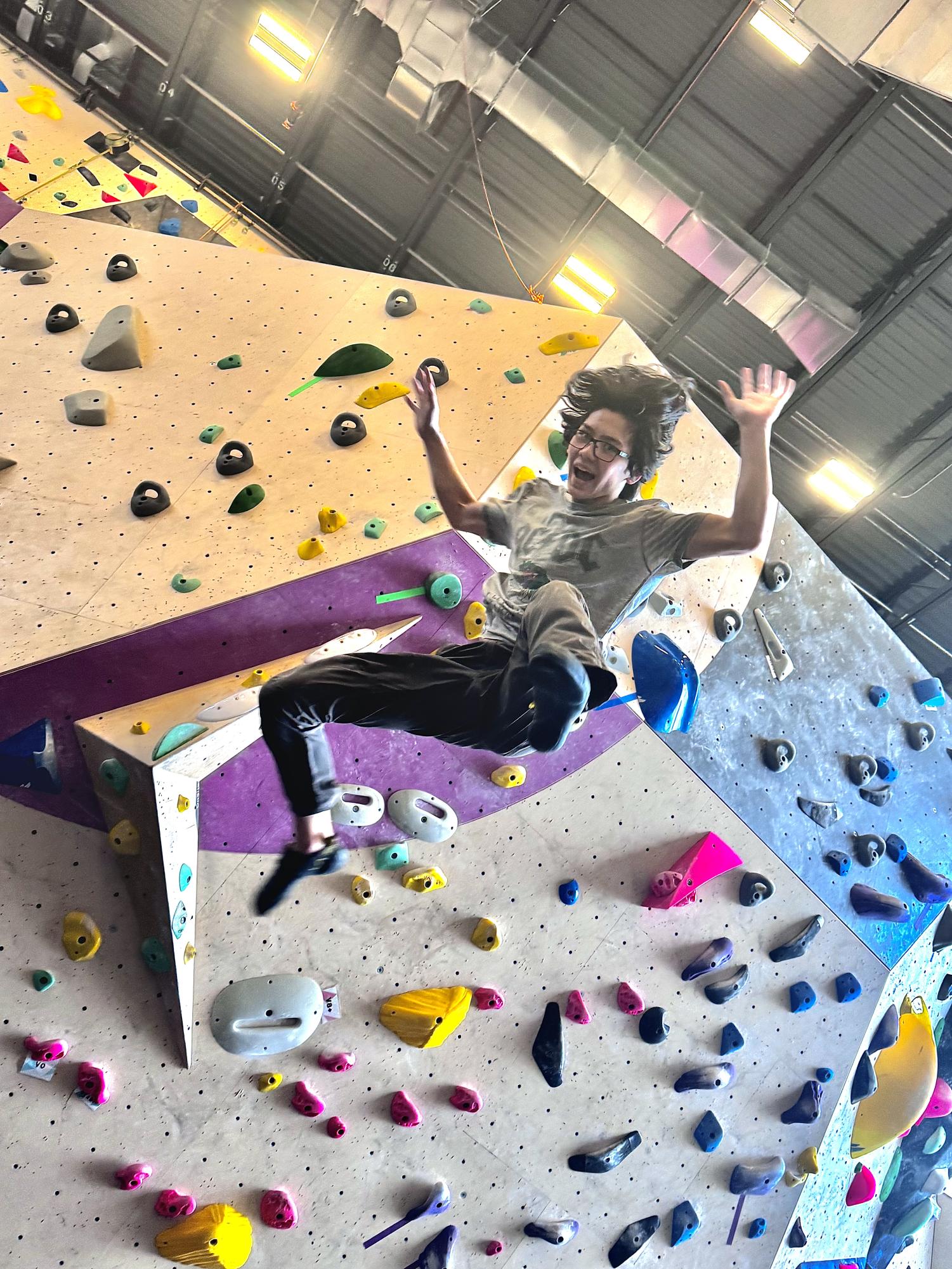 McKinnon jumps from the wall after completing a climb, making distance from the boulders so as to not hit himself or other climbers.